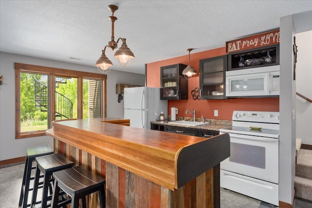 1704 156th St, Erin Prairie Twp, WI 54017 - kitchen featuring white appliances, glass insert cabinets, decorative light fixtures, a breakfast bar, and a textured ceiling