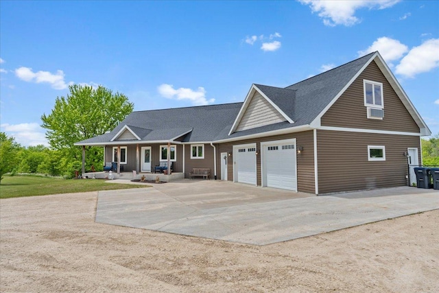 1704 156th St, Erin Prairie Twp, WI 54017 - view of front of property featuring covered porch, concrete driveway, a garage, and a shingled roof