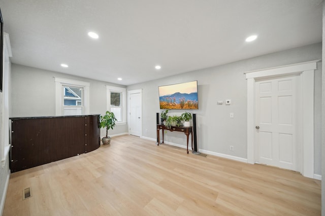 entryway featuring light wood finished floors, recessed lighting, and baseboards