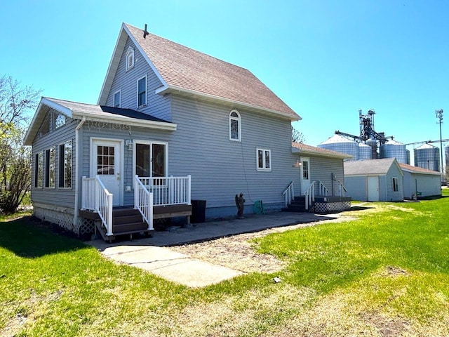 back of house with a lawn