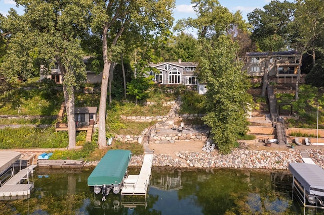 dock area featuring boat lift, a water view, and stairs