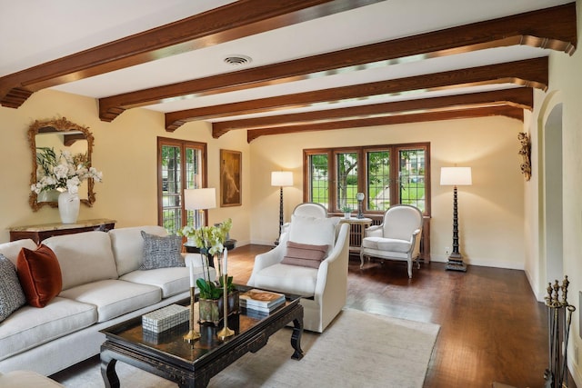living room featuring wood finished floors, beamed ceiling, and baseboards