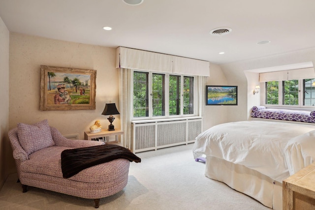 carpeted bedroom with radiator and recessed lighting