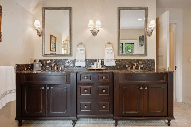 bathroom featuring double vanity and backsplash