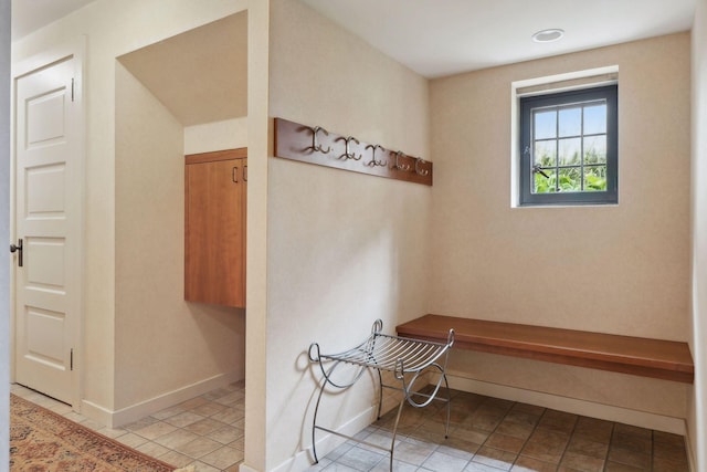 mudroom with baseboards and tile patterned floors