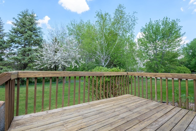 wooden terrace with a lawn