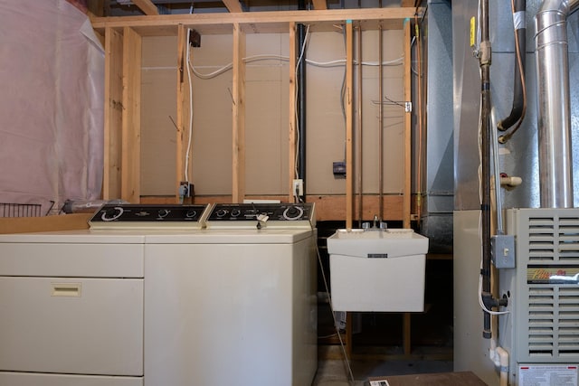 laundry room featuring washing machine and clothes dryer and heating unit