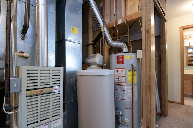 utility room featuring gas water heater and heating unit