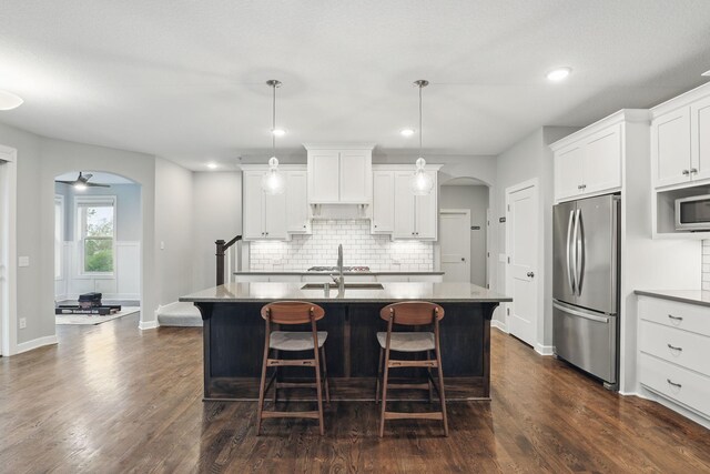 1088 Pine Hill Ln, White Bear Lake, MN 55127 - kitchen featuring appliances with stainless steel finishes, arched walkways, backsplash, dark wood-type flooring, and recessed lighting