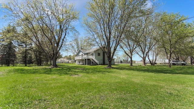 2070 Prospect Dr NE, Saint Cloud, MN 56304 - view of grassy yard featuring stairway and a deck