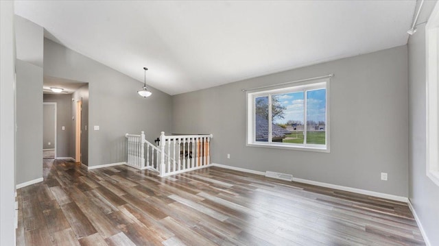 2070 Prospect Dr NE, Saint Cloud, MN 56304 - spare room with vaulted ceiling, wood finished floors, and baseboards