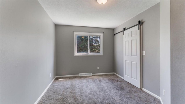 2070 Prospect Dr NE, Saint Cloud, MN 56304 - unfurnished bedroom with carpet floors, a barn door, baseboards, and a textured ceiling