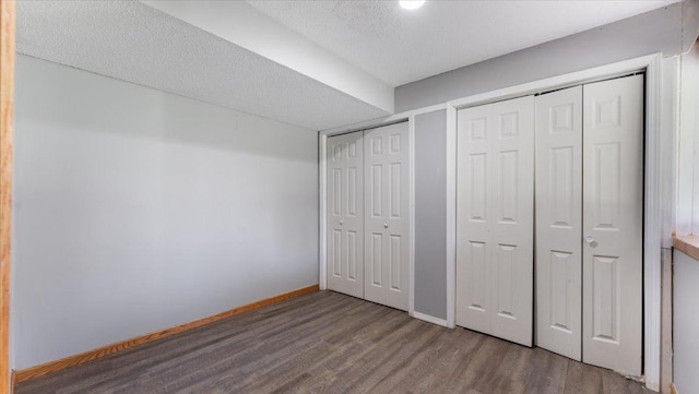 2070 Prospect Dr NE, Saint Cloud, MN 56304 - unfurnished bedroom with wood finished floors, two closets, and baseboards