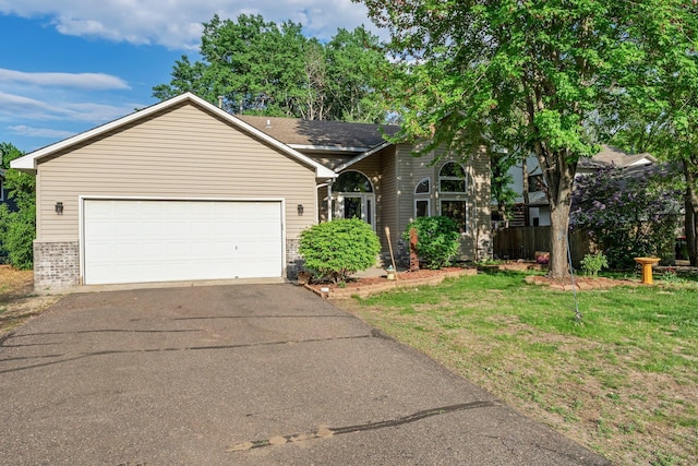 13367 Martin St NW, Andover, MN 55304 - view of front of house with asphalt driveway, brick siding, an attached garage, and a front lawn