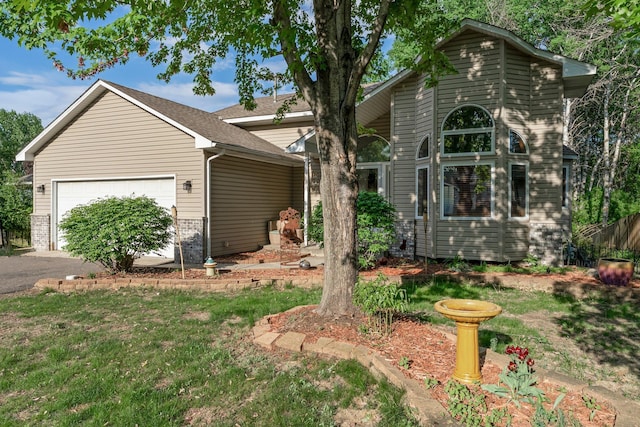 13367 Martin St NW, Andover, MN 55304 - view of front facade featuring a garage, driveway, and brick siding