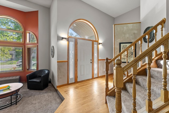 13367 Martin St NW, Andover, MN 55304 - entrance foyer with vaulted ceiling, healthy amount of natural light, wood finished floors, stairway, and baseboards