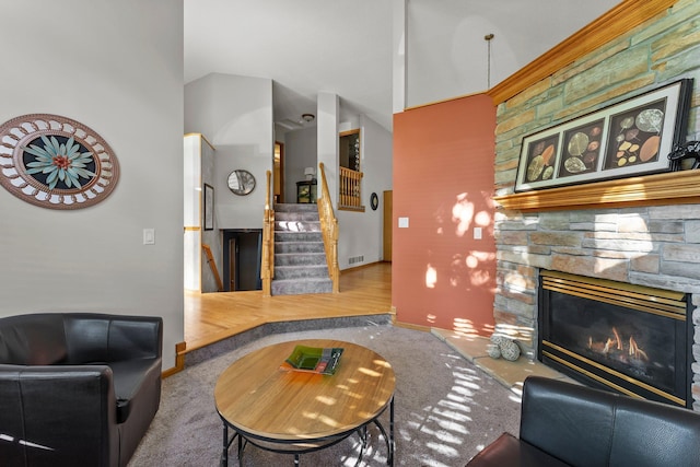 13367 Martin St NW, Andover, MN 55304 - carpeted living room with a fireplace, stairway, vaulted ceiling, and baseboards