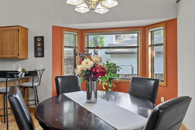 13367 Martin St NW, Andover, MN 55304 - dining space featuring a chandelier, light wood-style floors, and baseboards