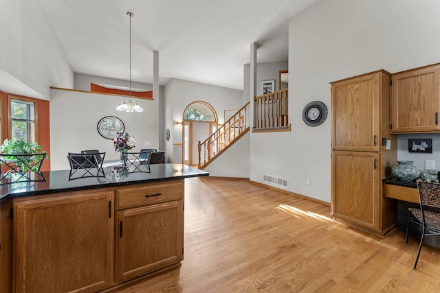 13367 Martin St NW, Andover, MN 55304 - kitchen featuring light wood finished floors, decorative light fixtures, a chandelier, and brown cabinetry