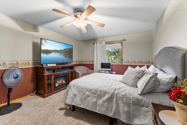 13367 Martin St NW, Andover, MN 55304 - carpeted bedroom featuring ceiling fan, a glass covered fireplace, and a textured ceiling