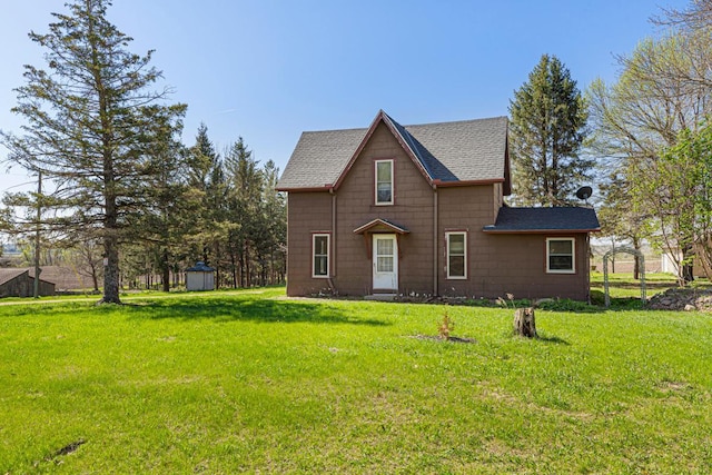 3020 320th St E, Sciota Twp, MN 55057 - view of front facade featuring a shingled roof, a storage unit, a front yard, and an outdoor structure