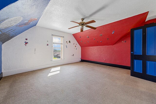 3020 320th St E, Sciota Twp, MN 55057 - additional living space featuring lofted ceiling, carpet floors, ceiling fan, baseboards, and a textured ceiling
