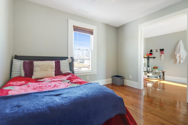 bedroom featuring wood finished floors and baseboards