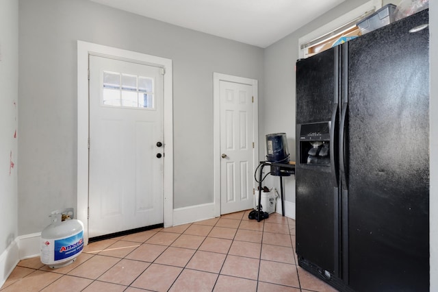 entryway featuring light tile patterned flooring and baseboards
