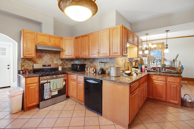 kitchen with black appliances, under cabinet range hood, backsplash, and dark stone countertops
