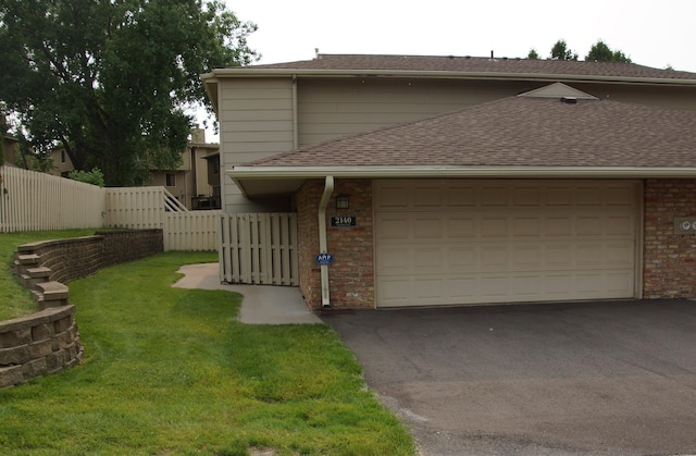 2140 Tamarin Trl, Golden Valley, MN 55427 - view of front facade with driveway, brick siding, a shingled roof, and a garage