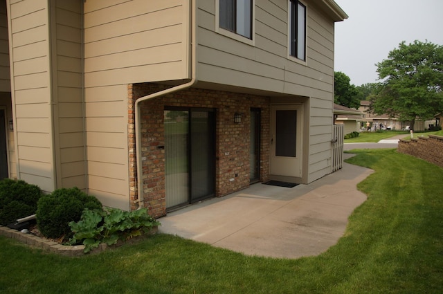 2140 Tamarin Trl, Golden Valley, MN 55427 - view of exterior entry featuring a yard and brick siding