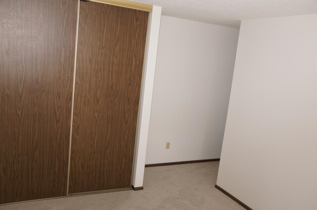 2140 Tamarin Trl, Golden Valley, MN 55427 - unfurnished bedroom featuring light colored carpet, a textured ceiling, and baseboards