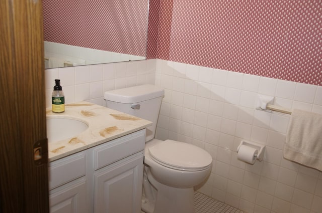 2140 Tamarin Trl, Golden Valley, MN 55427 - bathroom with wallpapered walls, toilet, vanity, tile walls, and tile patterned flooring
