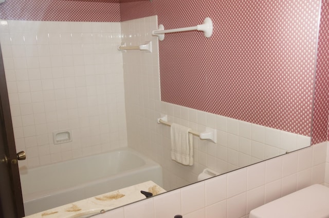 2140 Tamarin Trl, Golden Valley, MN 55427 - bathroom featuring wallpapered walls, tile walls, and bathtub / shower combination