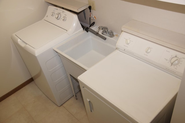 2140 Tamarin Trl, Golden Valley, MN 55427 - laundry room with washer and dryer, light tile patterned floors, and a sink