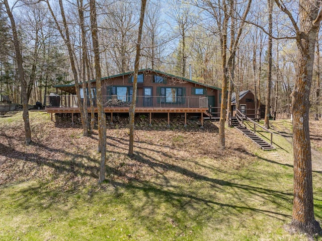 10380 Vermillion Point Dr NE, Deer River, MN 56636 - back of property with a deck, a lawn, and stairs