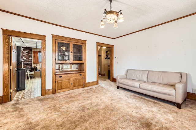 living area featuring a chandelier, crown molding, carpet, a textured ceiling, and baseboards