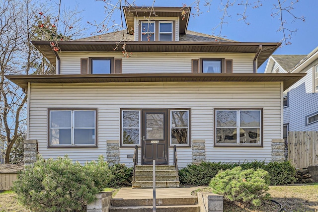 traditional style home featuring fence and entry steps