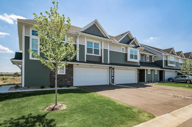 townhome / multi-family property featuring board and batten siding, a garage, driveway, a front yard, and a shingled roof