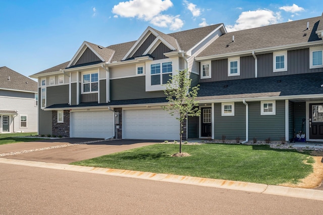 view of property with board and batten siding, an attached garage, driveway, and a front yard