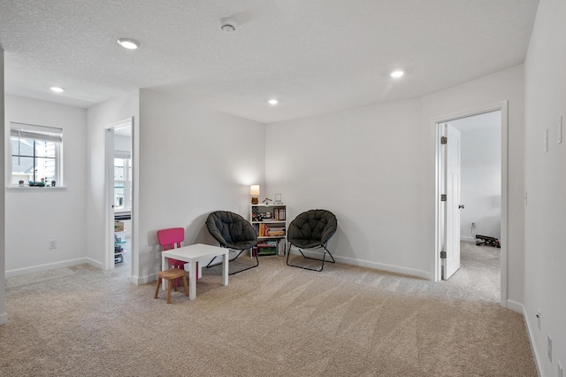 sitting room featuring carpet floors, recessed lighting, and baseboards
