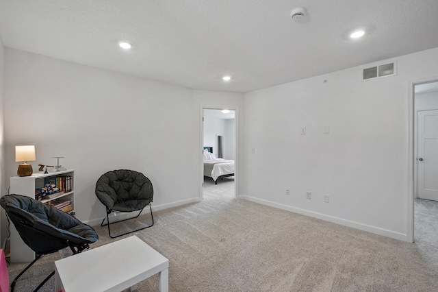 living area with carpet floors, baseboards, and recessed lighting