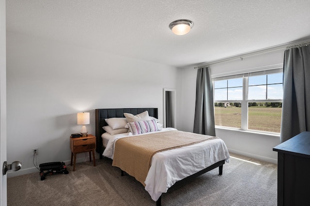 carpeted bedroom with a textured ceiling and baseboards
