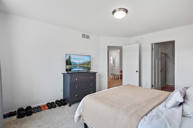bedroom featuring light carpet