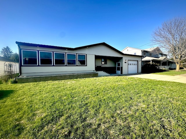 view of front of property with a garage, concrete driveway, and a front lawn