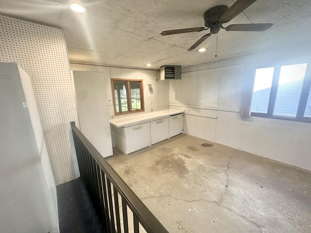 below grade area featuring a ceiling fan and plenty of natural light