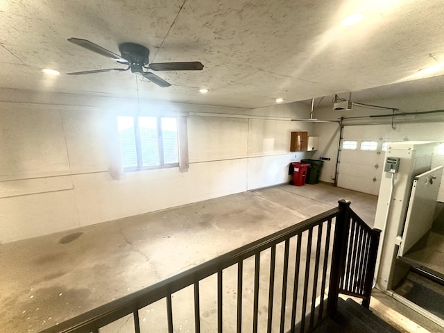 garage featuring ceiling fan, a garage door opener, and recessed lighting