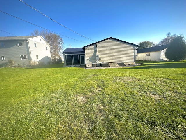 rear view of house with a lawn