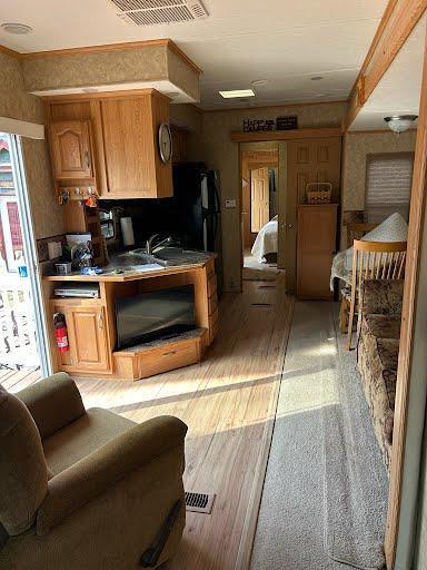 kitchen with brown cabinets and light wood-style floors