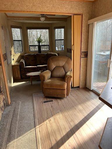 living room with plenty of natural light and wood finished floors